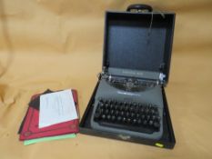 A CASED VINTAGE REMMINGTON RAND TYPE WRITER