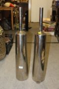 A PAIR OF MODERN TALL METAL BOTTLE SHAPED VASES HEIGHT - 75CM