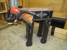 AN UNUSUAL EBONISED AND PAINTED ELEPHANT STAND H-46 L-55 CM