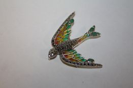 A PLIQUE-A-JOUR BROOCH IN THE FORM OF A BIRD IN FLIGHT