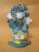 A CAST METAL DOORSTOP IN THE FORM OF FLOWERS IN A BASKET