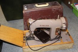 A CASED VINTAGE ELECTRIC SINGER SEWING MACHINE