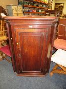 A 19TH CENTURY OAK HANGING CORNER CUPBOARD