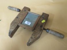 AN UNUSUAL WOODEN PICTURE FRAMING DEVICE