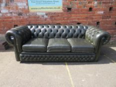 A GREEN LEATHER THREE SEATER CHESTERFIELD SETTEE