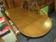 AN OAK ERCOL STYLE DROPLEAF DINING TABLE WITH SIX CHAIRS