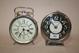 A MODERN WEST END ALARM CLOCK TOGETHER WITH A MODERN MANTEL CLOCK