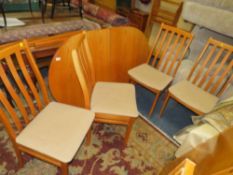 A RETRO TEAK EXTENDING DINING TABLE AND FOUR CHAIRS