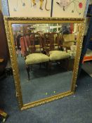 A LARGE MODERN GILT FRAMED RECTANGULAR WALL MIRROR 112 X 87 CM