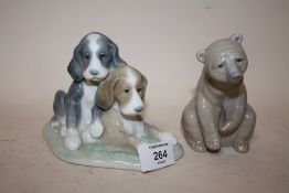 A LLADRO FIGURE OF A SEATED BROWN BEAR TOGETHER WITH A NAO FIGURE OF PUPPIES