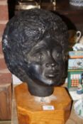 A PLASTER BUST OF LADIES HEAD RAISED ON WOODEN PLINTH, OVERALL HEIGHT 39 CM