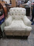 A LARGE UPHOLSTERED ARMCHAIR IN THE HOWARD AND SONS STYLE