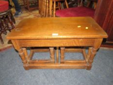 A SOLID OAK NEST OF TABLES W CM WITH A CIRCULAR WALNUT OCCASIONAL TABLE (2)