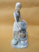 A NAO FIGURE OF A LADY BESIDE A FOUNTAIN