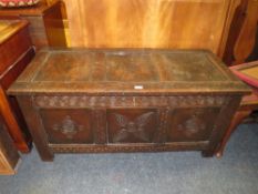A LATE 18TH CENTURY EARLY 19TH CENTURY OAK THREE PANEL CARVED COFFER H-56 W-120 CM
