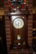 A REPRODUCTION MAHOGANY WALLCLOCK