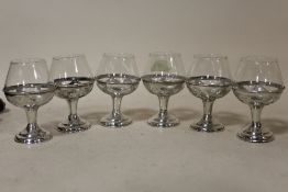 A SET OF SIX SMALL SILVER BASED DRINKING GLASSES STAMPED 925