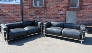 A PAIR OF MODERN BLACK AND CHROMED TWO SEATER SETTEES