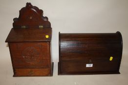 A VINTAGE CARVED OAK CANDLE BOX TOGETHER WITH A MAHOGANY TAMBOUR FRONTED LETTER RACK
