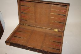 A LEATHER BOUND GAMES BOX IN THE FORM OF A BOOK