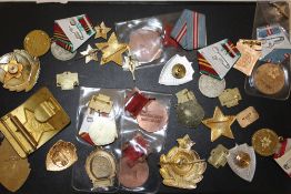 A BOX OF COLLECTABLES, RUSSIAN RELATED BADGES ETC