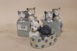 THREE NAO FIGURES OF CATS AND DOGS IN BASKETS