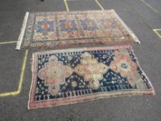 TWO EASTERN WOOLLEN RUGS - BOTH WITH DAMAGES, LARGEST 215 X 139 CM