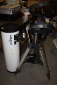 A LARGE MEADE LXD55 TELESCOPE ON TRIPOD WITH REMOTE, BATTERY PACK AND A HARD CASE OF LENSES