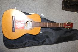 A GEISHA ACOUSTIC GUITAR IN CARRY BAG