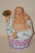 A LARGE MODERN CERAMIC FIGURE OF A SEATED BUDDHA - HEIGHT 39CM