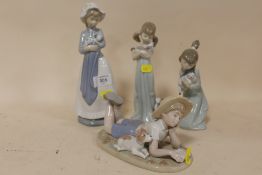 TWO LLADRO FIGURES OF GIRLS WITH CATS, TOGETHER WITH A NAO FIGURE OF A WOMAN WITH A PUPPY AND A