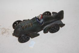A CAST METAL MODEL OF A MAN IN A RACE CAR LENGTH - 16CM