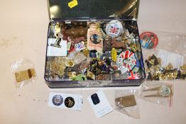 A TIN OF COLLECTABLE PIN BADGES ETC