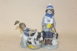 TWO LLADRO FIGURES OF A BOY AND GIRL WITH DOGS