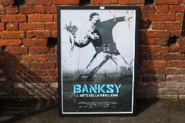 A LARGE FRAMED AND GLAZED BANKSY L'ARTE DELLA RIBELLIONE PRINT OVERALL SIZE INCLUDING FRAME -