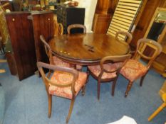 A LATE VICTORIAN MAHOGANY WIND-OUT DINING TABLE WITH TWO SPARE LEAVES RAISED ON FLUTED SUPPORTS WITH