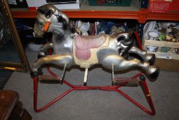 A TIN PLATE VINTAGE CHILD'S ROCKING HORSE ON STAND
