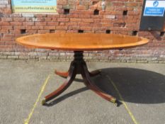 A WILLIAM IV MAHOGANY AND SATINWOOD OVAL TILT-TOP TABLE ON TURNED COLUMN AND FOUR REEDED