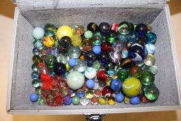 A SMALL HARD CASE OF MARBLES