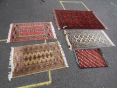A SELECTION OF FIVE EASTERN WOOLLEN RUGS - LARGEST 146 X 104 CM
