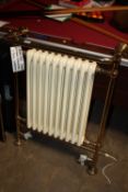 A DUEL FUEL CREAM AND GOLD RADIATOR AND TOWEL WARMER