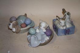 THREE NAO FIGURES OF RABBITS, A CAT AND A DOG IN BASKETS