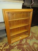A MODERN HONEY PINE GLAZED WALL CABINET 63 X 75 CM