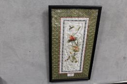 A FRAMED AND GLAZED ORIENTAL NEEDLEWORK, 33 X 13 CM