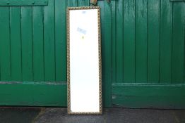 A GILT FRAMED WALL MIRROR, 100 X 31 CM