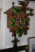 A CARVED WOODEN CUCKOO CLOCK