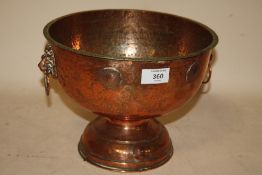 A HAMMERED FINISH COPPER FOOTED TWIN HANDLED BOWL WITH INSET GEORGIAN COINS TO OUTER RIM HEIGHT -