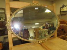 A GILT OVAL WALL MIRROR W-86 CM