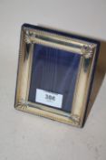 A HALLMARKED SILVER EASEL BACK PHOTO FRAME - REBATE SIZE 9.5CM X 7CM