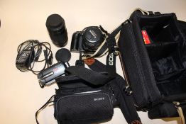 A CANON EOS30 CAMERA WITH CARRY BAG AND ACCESSORIES TOGETHER WITH A SONY HANDICAM